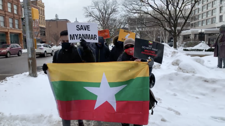 Protesters march along State St. in Rochester on Friday