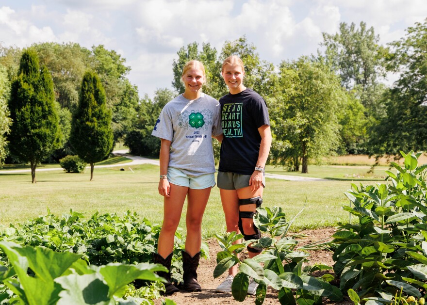 Claire, right, and her sister Evelyn standing in their garden.