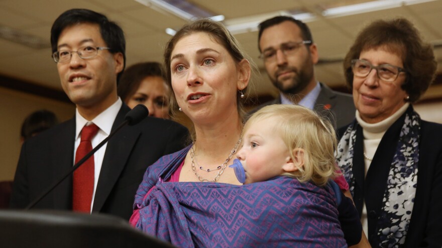 Leah Russin, of Palo Alto, Calif., holds her son, Leo, 16 months, as she speaks Wednesday at a news conference in support of proposed state legislation that would require parents to vaccinate all school children.