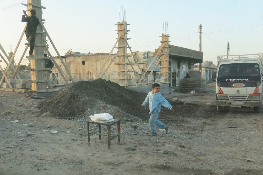 A child walks through a section of Raqqa that is being rebuilt.