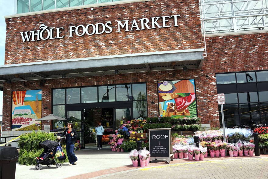 People walk out of a Whole Foods Market in the Brooklyn borough of New York. (Spencer Platt/Getty Images)
