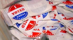 A bin of "I Voted Today" stickers rests on a table at a polling place, Tuesday, Sept. 13, 2022, in Stratham, N.H. (AP Photo/Charles Krupa)