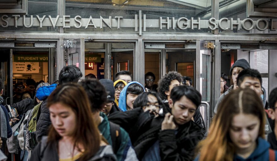 In this March 13, 2020, file photo, students at Stuyvesant High School leave after classes in New York at the onset of the coronavirus pandemic.