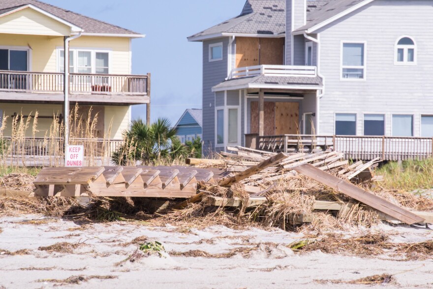 Beach houses and a sign that reads, "Keep Off Dunes" 