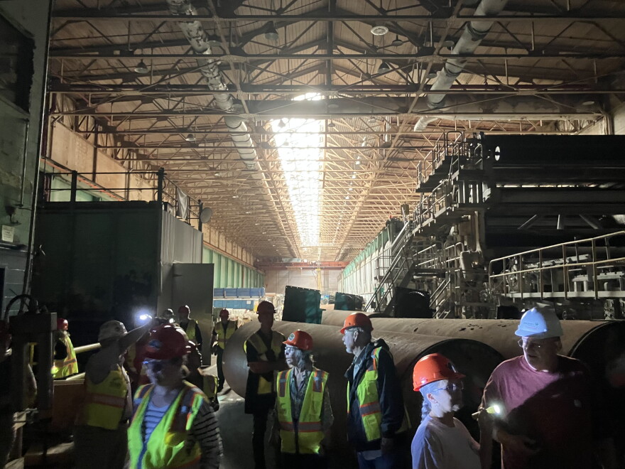Participants in one of the first public tours of the former Pactiv Evergreen paper mill walk through the facility Thursday, Aug. 13, 2026.