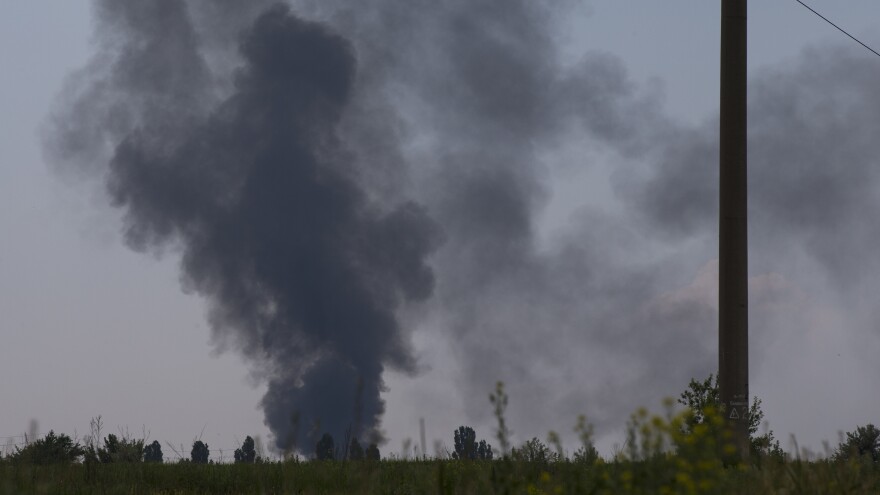 Black smoke rises from the spot where a Ukrainian army helicopter was shot down outside Slovyansk, Ukraine, on Thursday. Rebels shot the craft down amid heavy fighting around the eastern city.