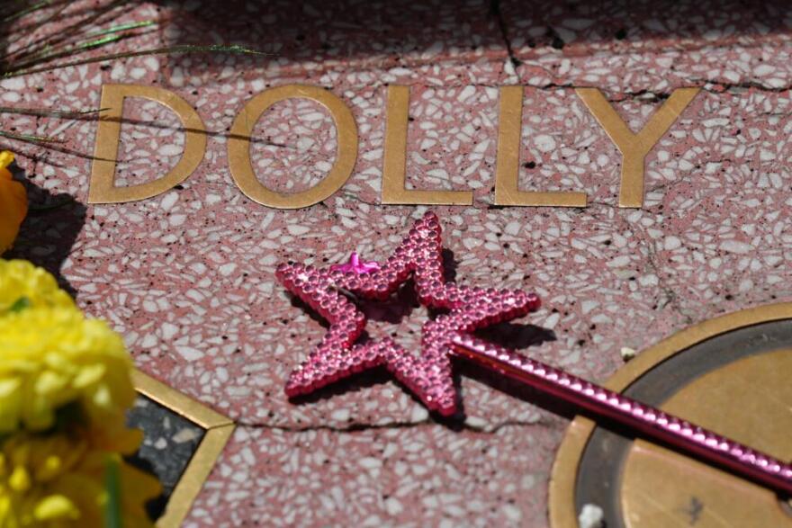 A wand with a star is placed over Dolly Parton's star on the Hollywood Walk of Fame Tuesday, Aug. 25, 2026, in Los Angeles. (Chris Pizzello/AP)