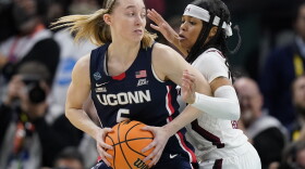 UConn's Paige Bueckers tries to get past South Carolina's Destanni Henderson during the first half of a college basketball game in the final round of the Women's Final Four NCAA tournament Sunday, April 3, 2022, in Minneapolis.