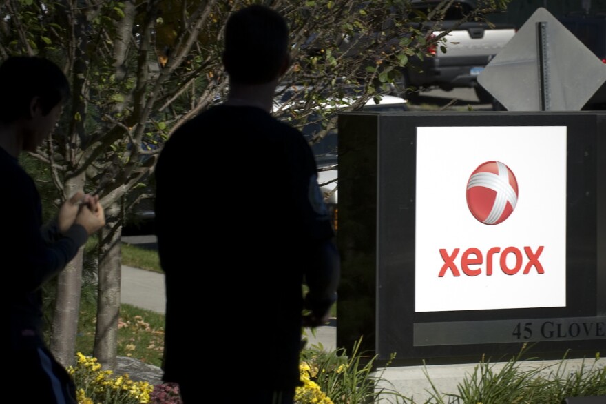 FILE, 2008: Unidentified people pass the Xerox logo at Xerox Corporation headquarters in Norwalk, Conn.