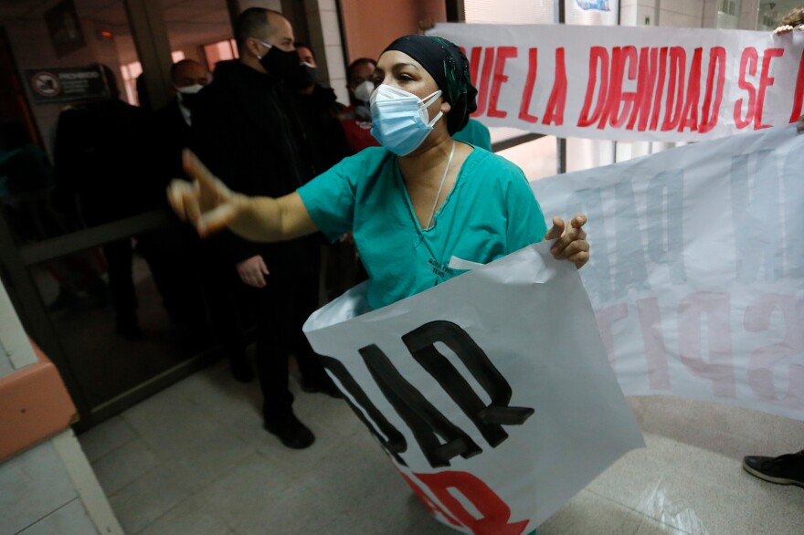 A nurse protests Chile's handling of the coronavirus pandemic. The country now has the highest per capita infection rate of any major country — 13,000 cases for every 1 million people.