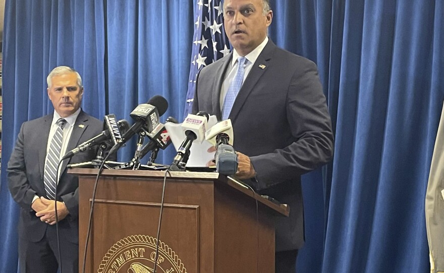 Acting U.S. Attorney Vipal J. Patel, center, accompanied by FBI Special Agent in Charge Chris Hoffman, speaks during a news conference announcing FirstEnergy Corp.'s prosecution agreement in Cincinnati on July 22, 2021.
