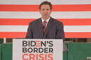 Gov. Ron DeSantis signs an immigration bill during an appearance in Jacksonville.