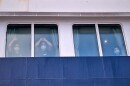 Passengers watch as others are disembarked from the hantavirus-stricken cruise ship MV Hondius at the port of Granadilla in Tenerife, Canary Islands, Spain, Sunday, May 10, 2026.