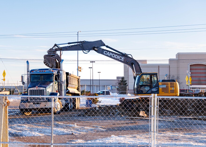 Construction equipment works on a demolition project