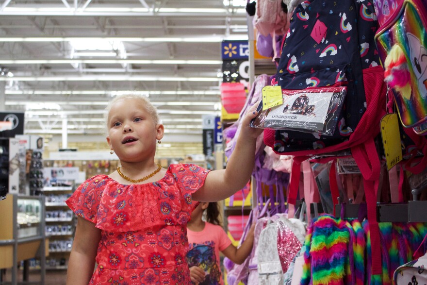 Aviana Conyers browses backpacks while shopping.