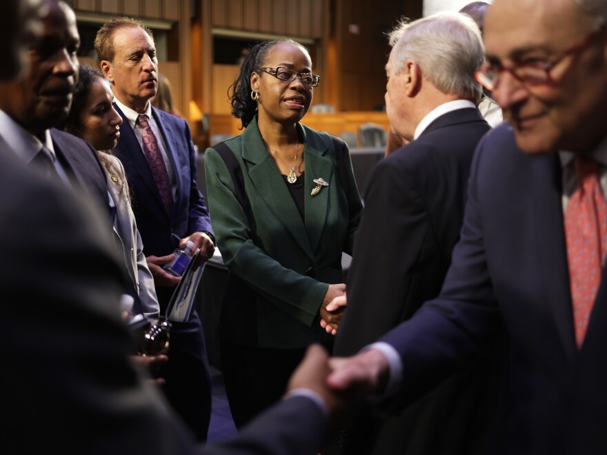 Senate Majority Leader Chuck Schumer, D-N.Y., right, and Majority Whip Dick Durbin, D-Ill., second from right, greet family members of Buffalo shooting victims, including Kimberly Salter, center, the widow of Aaron Salter Jr., a security guard who died in the mass shooting at the Tops supermarket, after a hearing on gun violence on Tuesday.