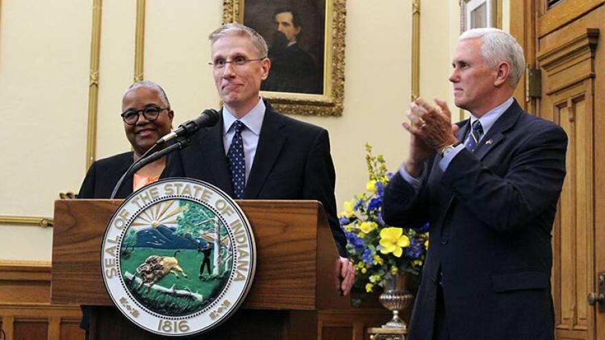 Geoffrey Slaughter at the podium, joined by his wife Julie and Gov. Mike Pence.