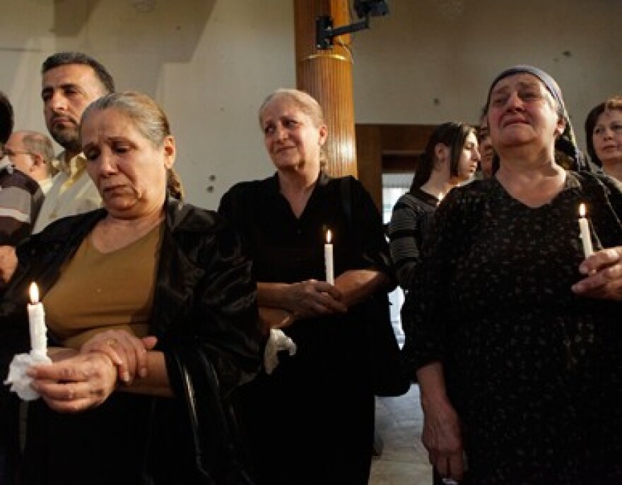 Iraqi Christians mourn following a 2010 attack on a Baghdad church that killed dozens