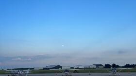 Planes sit on the tarmac at Omar N. Bradley Regional Airport at dusk. Teams are only allowed to fly during daylight hours, and must stay overnight where they are after the sun sets.