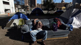 A homeless man in 2008 sleeps beneath Interstate 10 in New Orleans where hundreds of homeless people sleep each night. (Mario Tama/Getty Images)