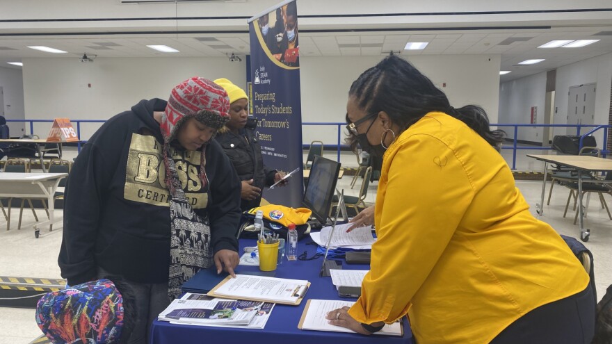 Former HIM By HER parent Samone Curry talked to an employee with Indy STEAM Academy during a school enrollment at HIM By HER Collegiate School for the Arts, which will close in January 2023.