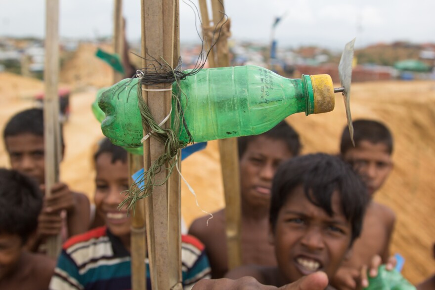 Kids in the Balukhali Rohingya refugee camp try to get the propellers on their homemade toy airplanes to spin as fast as possible.