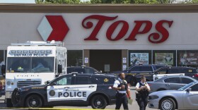 Police walk outside the Tops grocery store on Sunday, May 15, 2022, in Buffalo, N.Y.