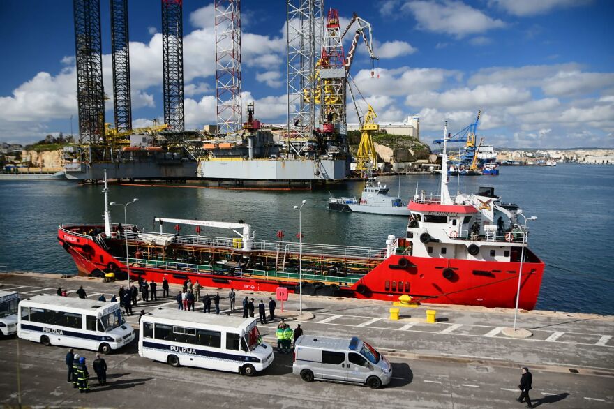 Police forces stand on the pier Thursday near El Hiblu 1, which reportedly was hijacked by migrants it had rescued off Libya. Maltese armed forces took control of the vessel on Thursday.