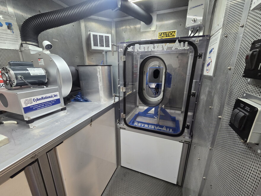 A device in the Crime Gun Intelligence Mobile Command Center allows deputies to safely fire a weapon in order to obtain a spent shell casing. The marks on that casing are then analyzed using computers in the mobile center to find matches in the ATF's database.