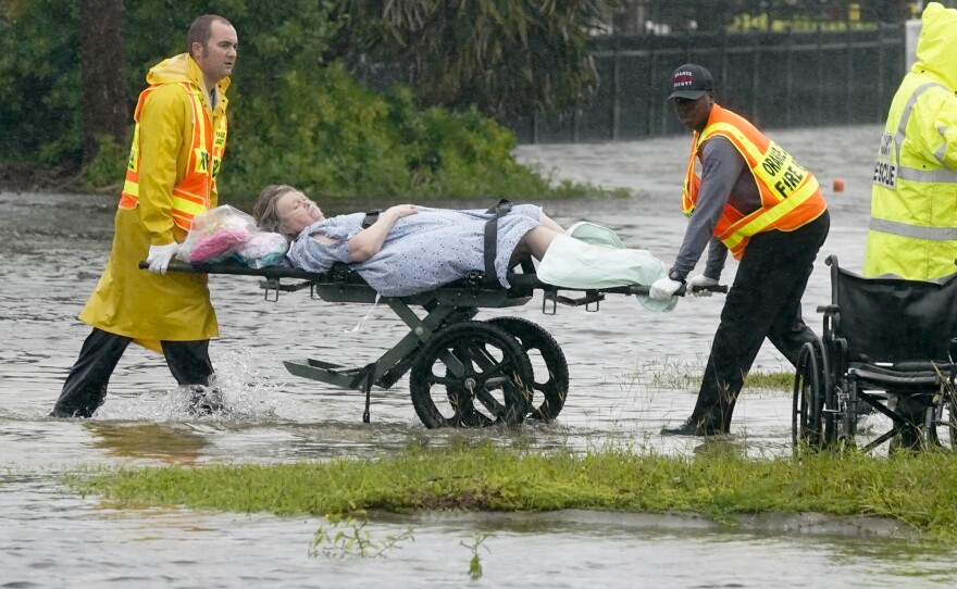 Authorities transport a person out of the Avante nursing home in the aftermath of Hurricane Ian, Thursday, Sept. 29, 2022, in Orlando, Fla. Hurricane Ian carved a path of destruction across Florida, trapping people in flooded homes, cutting off the only bridge to a barrier island, destroying a historic waterfront pier and knocking out power to 2.5 million people as it dumped rain over a huge area on Thursday.