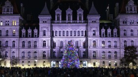 A Christmas tree is lit outside the New York State Capitol in Albany