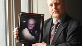 State long-term care ombudsman Bill Whited, holding a picture of his grandmother, Pearl Wolf.