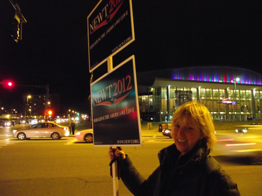 State Representative Laurie Pettengill waves signs for Newt Gingrich outside of the Verizon Center.
