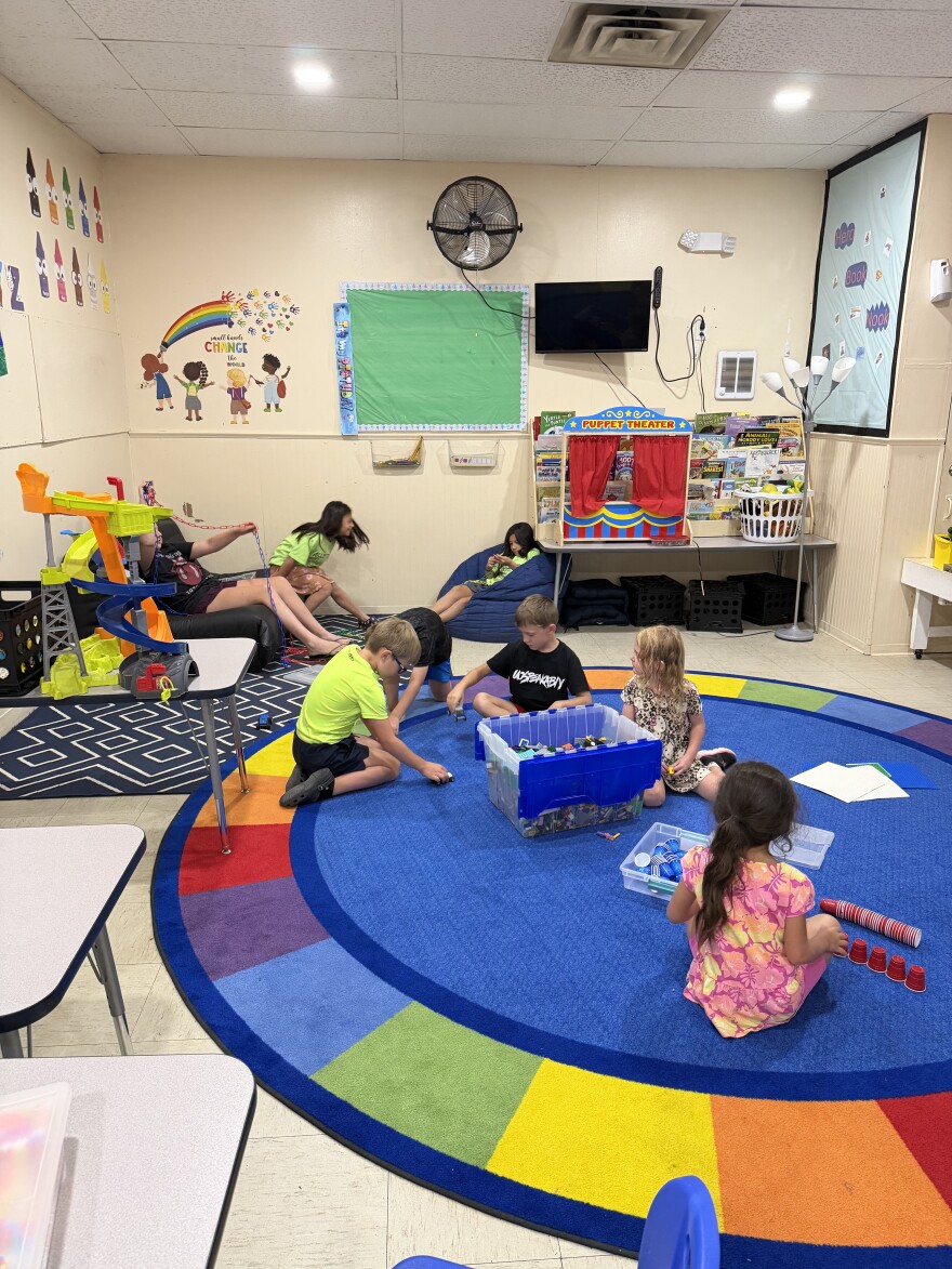 Children play inside a childcare center classroom