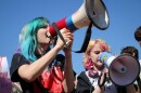 Students Swoo Harter and Maeryn LaCaze joined dozens of organizers and workers at the corner of Westport Road and Broadway Boulevard to protest federal immigration action and data centers in their communities.