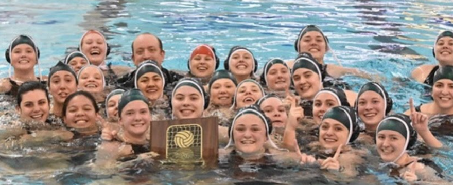 The team displays their Big Ten Championship plaque after their win to clinch the title.