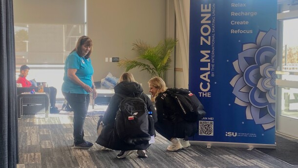 Two athletes meet a therapy dog in the Calm Zone at the ISU World Cup Speed Skating competition at the Utah Olympic Oval in Kearns, Nov. 15, 2025.