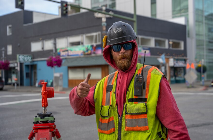Ben Adler, of Homer, works on a surveying job in downtown Anchorage on August 15, 2025.