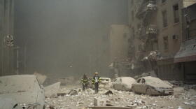 FIremen walk through a dust and debris covered street in lower Manhattan Tuesday, Sept. 11, 2001, after a terrorist attack at the World Trade Center. (Richard Cohen/AP)