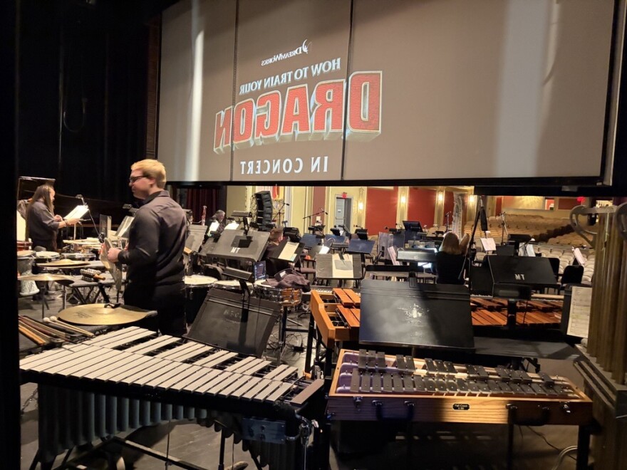 The percussion section of the Missouri Symphony performance of the 'How to Train Your Dragon' was set up behind the projector screening the film.
