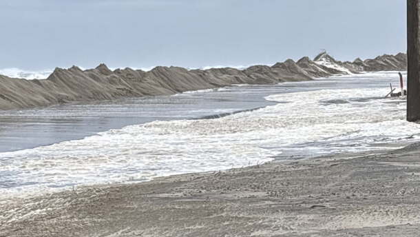 Two to four feet of ocean water is flooding vulnerable areas, forcing state transportation crews into a non-stop battle to keep sand and ocean overwash from destroying Highway 12. The road is shut down from the Marc Basnight Bridge to Rodanthe.