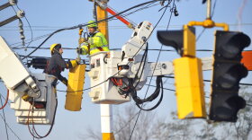 Workers from the Connecticut Department of Transportation and Connecticut Light & Power work on downed power lines on Route 5 in South Windsor, Conn., Monday, Oct. 31, 2011.
