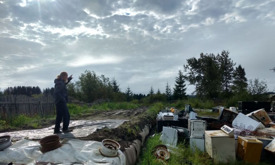 Gustavus’s Disposal and Recycling Center manager Paul Berry stands atop bales of municipal solid waste buried at the city’s landfill site. (Photo by Jacob Resneck/KTOO)