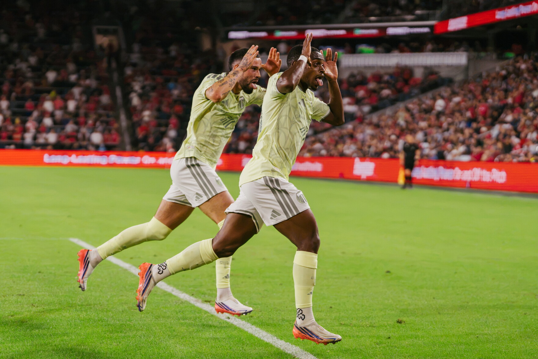 Portland Timbers midfielder David Pereira Da Costa (#10), right, and forward Kristoffer Velde (#99) taunt St. Louis City SC supporters after scoring a goal during their match at Energizer Park on Wednesday, Oct. 28, 2026, in St. Louis’ Downtown West neighborhood.