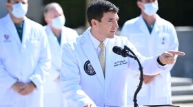 White House physician Sean Conley answers questions surrounded by other doctors, during an update on the condition of US President Donald Trump, on October 4, 2020, at Walter Reed Medical Center in Bethesda, Maryland. (Photo by BRENDAN SMIALOWSKI/AFP via Getty Images)