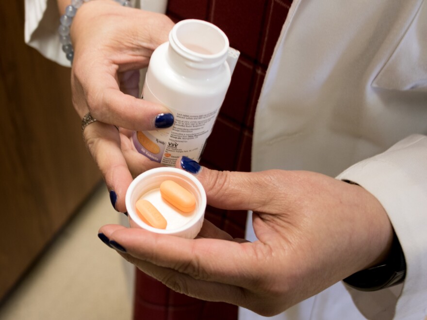 Dr. Michelle Salvaggio holds one of the medicines she prescribes to her patients with HIV.