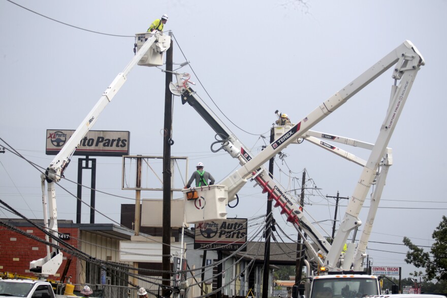 Utility crews work to restore electricity in Houston, Thursday, July 11, 2024. Officials say about 500,000 customers still won't have electricity into next week as wide outages from Hurricane Beryl persist. 