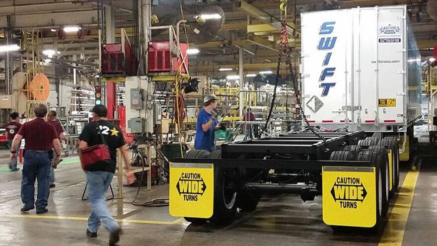 Workers assemble truck trailers at Wabash National's Lafayette factory.
