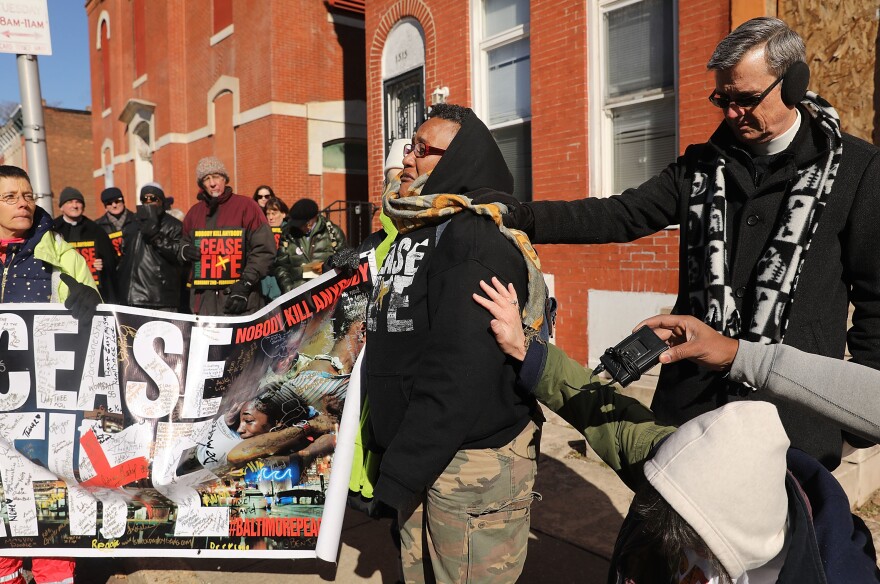 Activists participate in a "Peace and Healing Walk" during Baltimore's third "Ceasefire Weekend" on February 3, 2018.