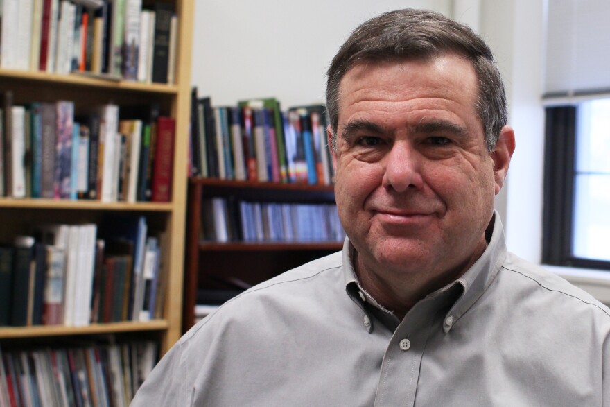 Ben Moore sits in the Bosnia Memory Project office at Fontebonne University